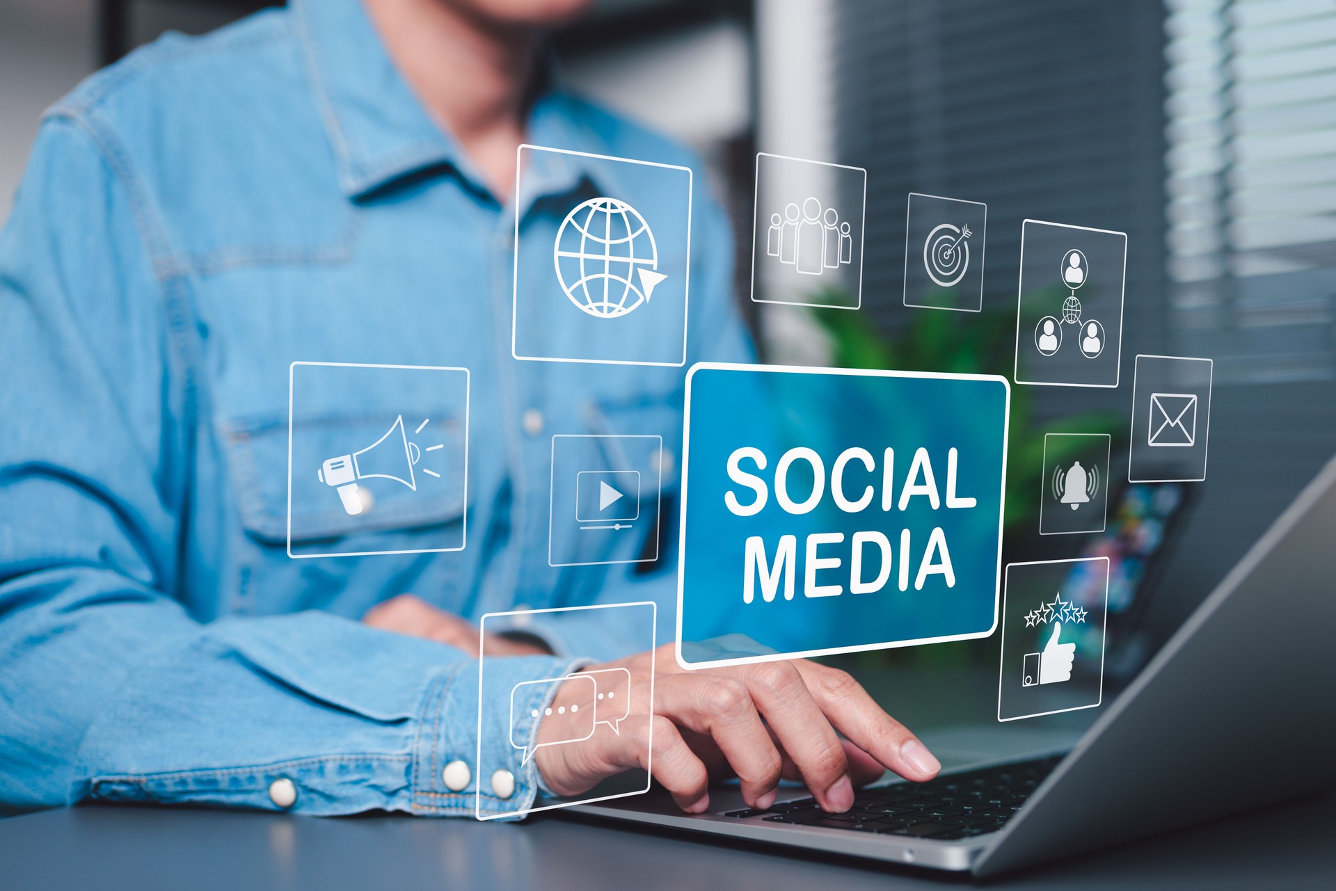 Social Media Marketing and Digital Engagement Concept. A person using laptop with virtual icons and words Social Media, symbolizing online marketing, content sharing, digital communication strategies,