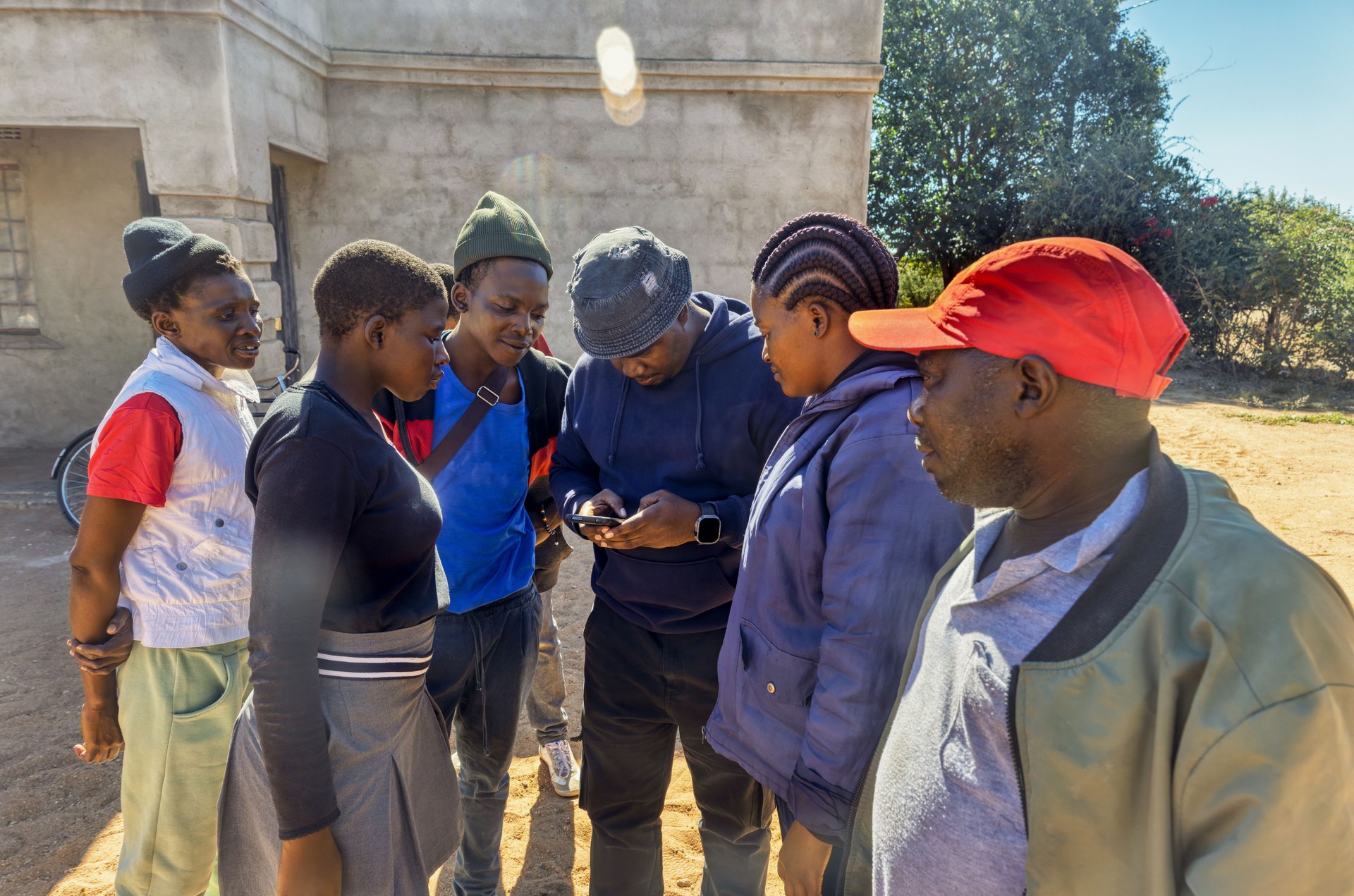 Africa village, charity social worker teaching villagers wireless technologies for entrepreneurship in rural areas